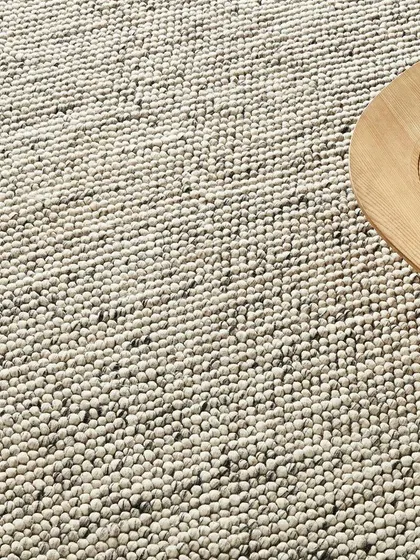 A macro shot of a looped-pile rug, focusing on its nubby texture. This type of detail shot is crucial for conveying the feel and quality of a rug to an online shopper.