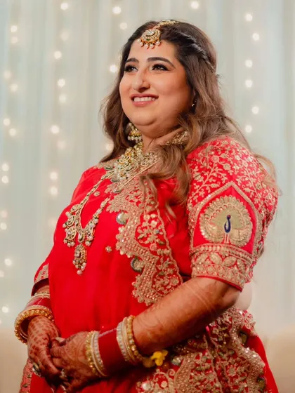 The bride looking radiant and happy. Her hair is styled in soft waves, and her makeup is a perfect balance of glam and elegance.