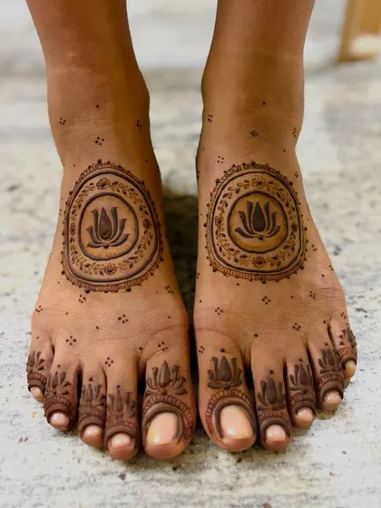 A clear, top-down view of Niranjana's minimal lotus feet mehendi.