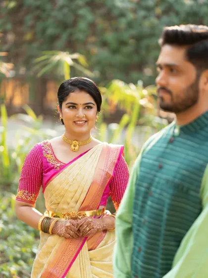 A candid shot of the couple. The bride's makeup looks fresh and beautiful in the natural outdoor light.