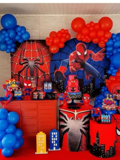 An action-packed Spiderman-themed birthday party. This setup includes multiple backdrops, character props, and balloon decorations in Spiderman's signature red and blue colors.