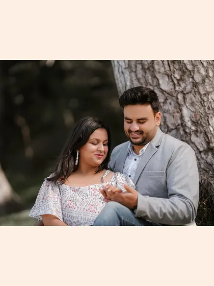 A sweet and simple pre-wedding portrait. The focus is on the couple's gentle interaction and the soft, natural lighting.