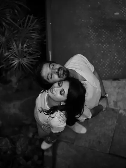A unique high-angle perspective captured in black and white. This artistic shot focuses on the couple's upward gaze, creating a dramatic and intimate portrait.
