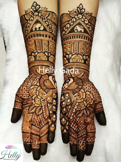 A grand and intricate design perfect for a bride or her sister. This full-arm piece features peacocks, elephants, and floral patterns, all tied together with detailed gridwork and traditional motifs.