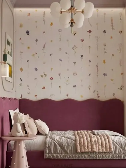 A close-up of the whimsical details, including the floral wallpaper, scalloped headboard, and adorable stuffed animal, that make this room so special.