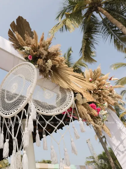 A detailed shot of the dreamcatchers and floral arrangements on the event arch. We focus on these small details to ensure every element of the decor is cohesive and beautifully crafted.