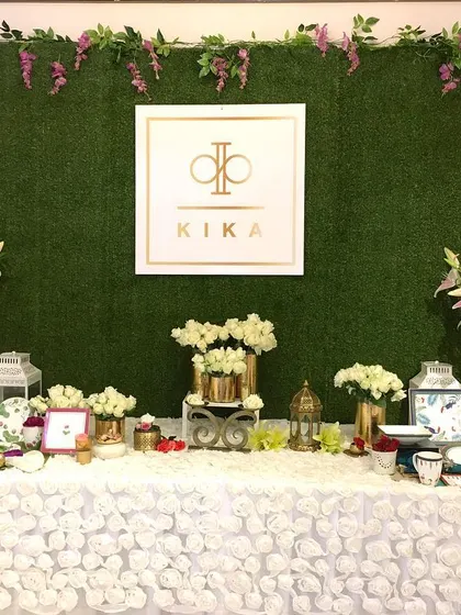 This custom hedge wall served as both a branded installation and a photo backdrop for the KIKA Tableware launch. The lush green wall provides a high-contrast background for the company's gold logo, making it a central point for brand visibility and guest photos.