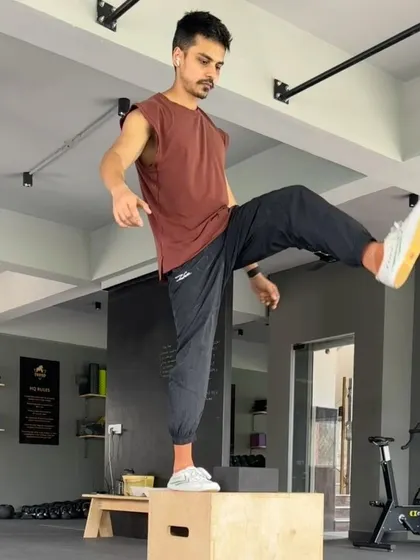 Working on single-leg balance and strength with a pistol squat progression on a box. This kind of unilateral work is great for identifying and fixing imbalances.
