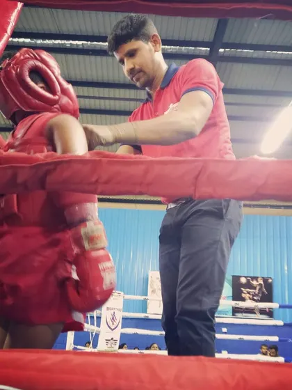 It’s all about focus before a match. Here, I’m in the corner with one of my young Muay Thai fighters, getting her ready to compete at the MTI National Championship. I make sure every kid is prepared and safe in the ring.