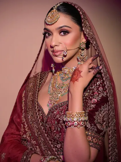 The complete look, with the dupatta elegantly draped over the head. The makeup is designed to be captivating both up close and from a distance.