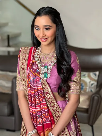 The final look is one of pure elegance and grace. The soft makeup perfectly complements the traditional outfit and stunning jewellery.