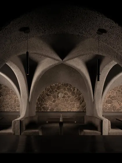 A symmetrical composition of the dining pods. The raw stone backdrops contrast with the smooth, sculpted concrete, creating a rich tactility and a visual anchor for each seating area.