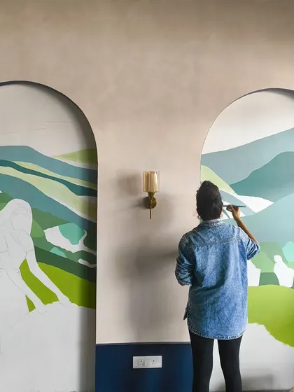 Working on a large, two-panel mural for a cafe. The design features serene, rolling green hills inspired by tea plantations.