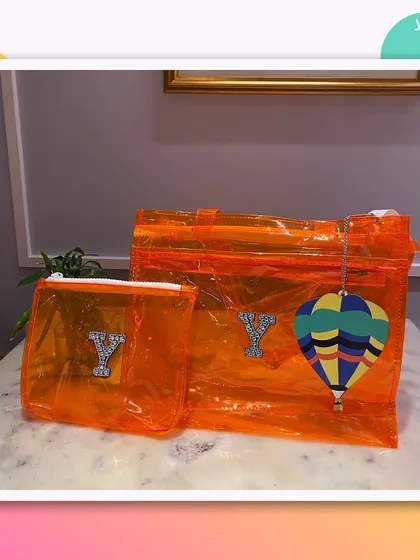 This orange jelly tote and pouch set is personalised with a 'Y' and a hot air balloon charm.
