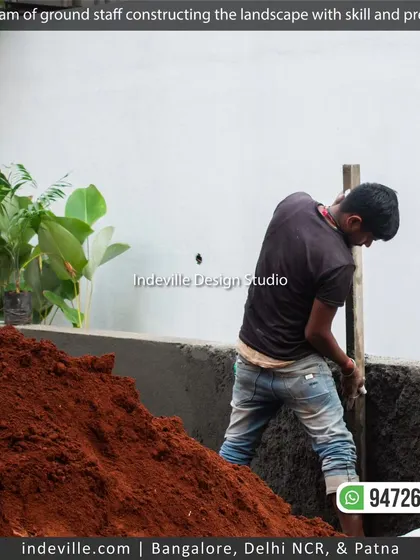 A team member working on the masonry for a raised planter bed. This shows the construction side of my landscape service, all done in-house.