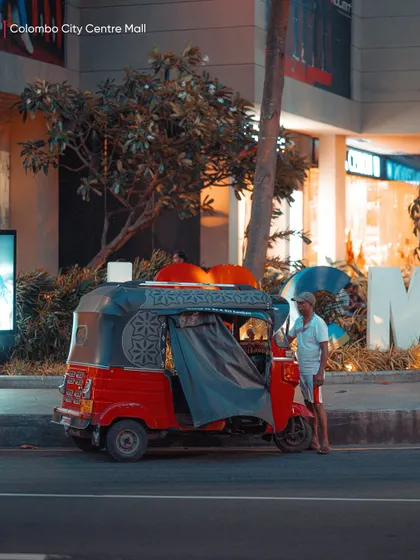 A colorful tuk-tuk parked outside the Colombo City Centre Mall. This image captures the blend of traditional transport and modern city life.