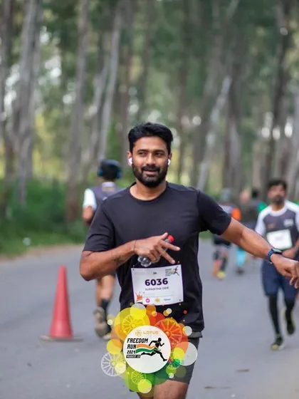 A scenic shot of a runner on the tree-lined course of the Freedom Run, showcasing the beautiful environment of our events.
