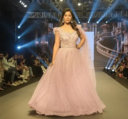 Another stunning shot of the Muave Pink gown. The way it catches the light on the runway is just magical. You can get this dream gown for your special day.