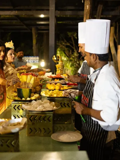 Guests interacting with our chefs at a live chaat and fruit station.