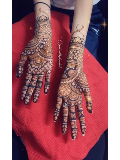 A beautiful Indian design with intricate checks and curves, showing the rich dark stain of the henna.