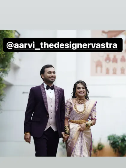 A beautiful shot of the couple walking hand in hand. Their coordinated reception outfits make them look like a true power couple.