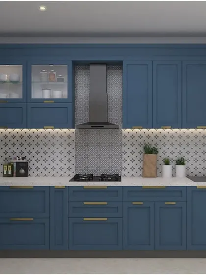 A Victorian-inspired L-shaped kitchen in a beautiful blue-grey matte finish. The design features classic cabinet profiles, a mosaic backsplash, and elegant gold handles.