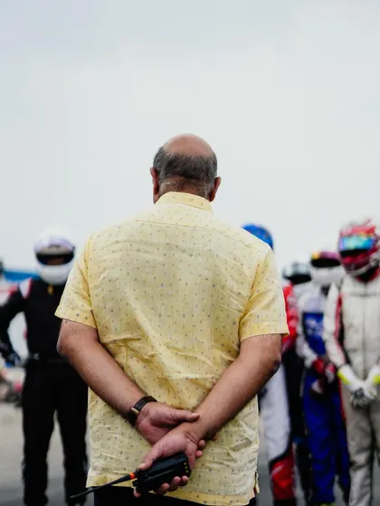 An official watches over the drivers on the grid.