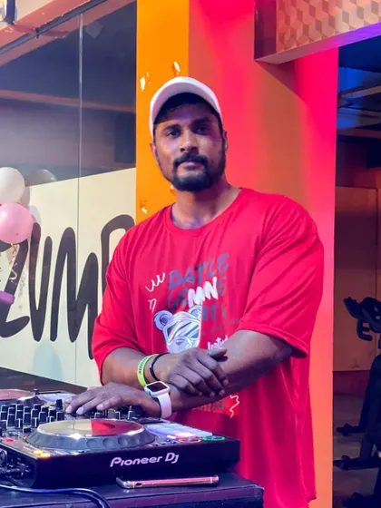 Posing for a photo behind the decks at my gym. A proud and happy moment.