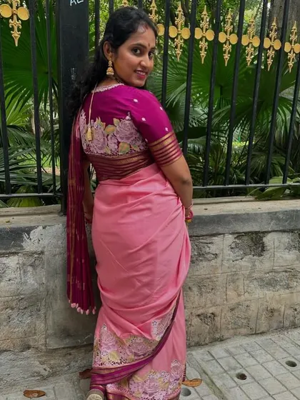 A beautiful back shot of our client, showcasing the detailed embroidery on her custom-stitched blouse.