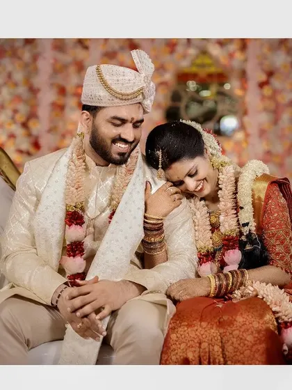 An intimate and joyful candid of the couple on their wedding couch, lost in a happy moment together.