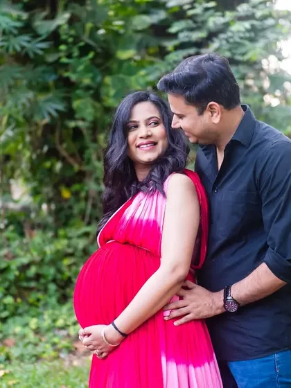 A classic, loving embrace. This close-up focuses on the couple's happy interaction and the beautiful baby bump, creating a warm and intimate portrait.
