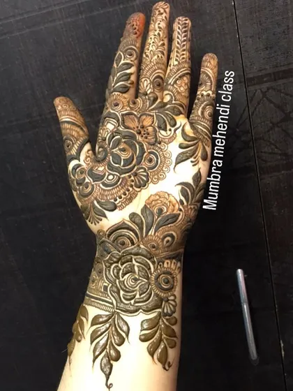 A full-hand design with intricate floral work, perfect for any celebration.