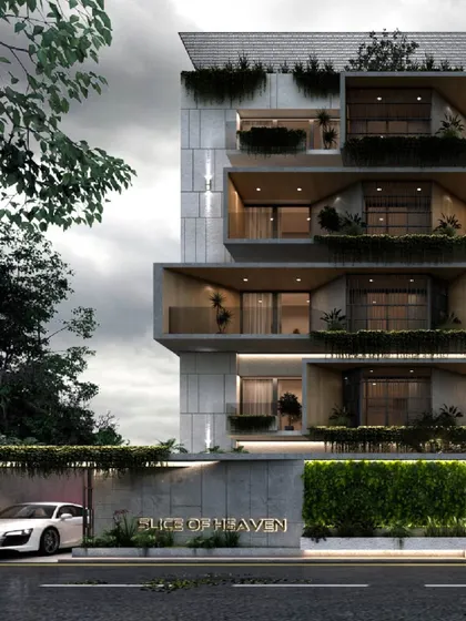 Named 'Slice of Heaven', this apartment building facade uses stacked, offset volumes to create private, deep-set balconies. Each unit is given a connection to the outdoors, with integrated planters that bring a layer of green to the concrete structure.
