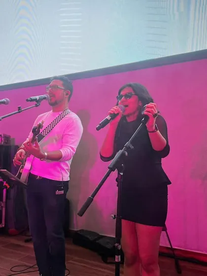 Sharing the stage and a microphone with my guru. This photo shows our close collaboration and the dynamic energy we have when performing together.