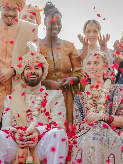 A beautiful group portrait with the couple and their diverse group of friends and family showering them with love after the ceremony.