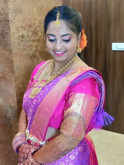 A quiet moment captured during a wedding ritual. The draping highlights the beautiful texture and color of the silk saree, and her elegant pose shows how comfortable she is.