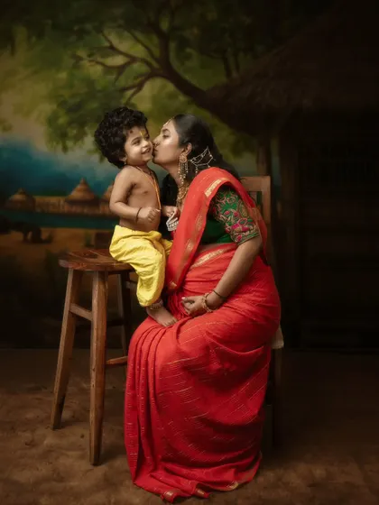Love knows no bounds. This tender moment captures a mother and her young son, both in traditional attire, sharing a sweet kiss.