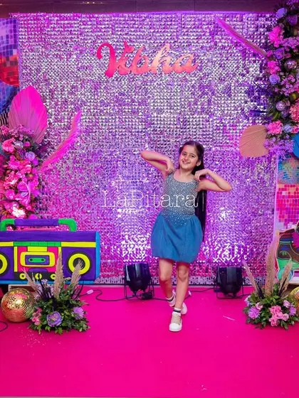 The birthday girl dancing on her disco-themed stage, showing how the setup creates a fun and engaging atmosphere.