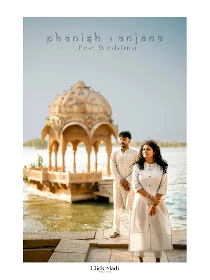 Phanish and Anjana's pre-wedding shoot in Rajasthan, set against the stunning architecture of Gadisar Lake. Their coordinated white outfits create a look of timeless elegance.
