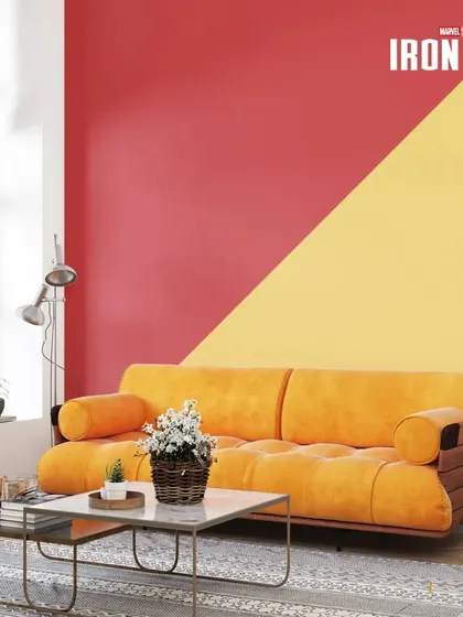 A living room painted in Iron Man's signature red and gold colours, creating a bold, diagonal design for a modern and fun space.