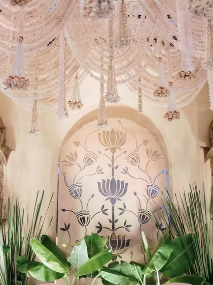 A closer view of the heritage-inspired stage, showing the rich textures of the hanging florals and the ornate details of the golden jharokhas.