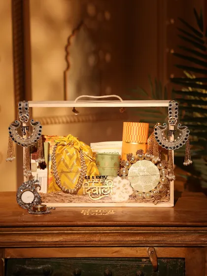 This yellow and green themed Diwali hamper is perfect for a vibrant and cheerful gift. It includes a mix of modern and traditional items, decorated with beautiful silver ethnic hangings.
