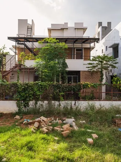 A view of the Samvrruddhi residence a year after completion, now enveloped in lush greenery. Our designs encourage this integration with nature, allowing the home to evolve and grow with its landscape.