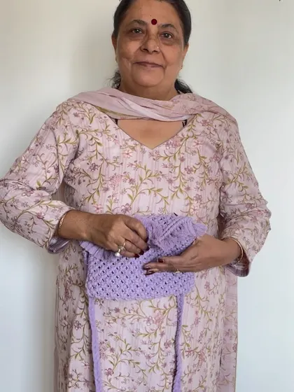 Here I am with a lovely lavender macrame sling bag. We charge a little extra for linings because we custom source the fabric to match your chosen color and hand stitch it.