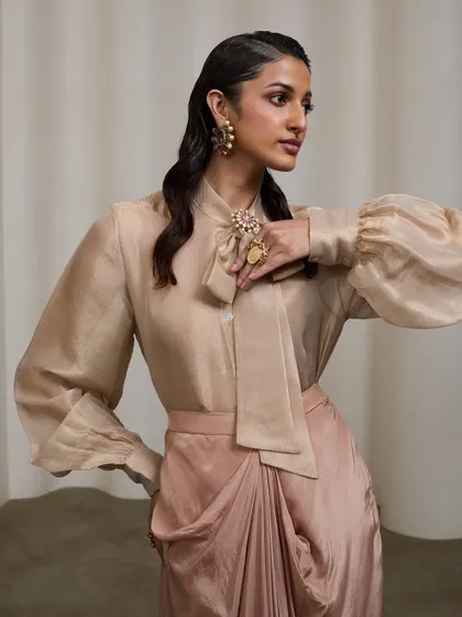 A three-quarter view that showcases the accessories and the elegant silhouette of the garment. The pose is dynamic yet poised, fitting for a royal-inspired look.