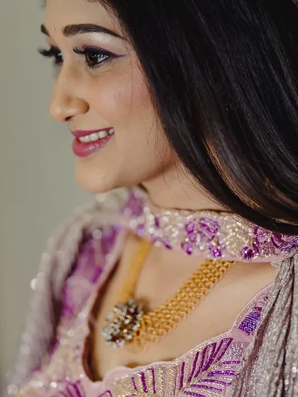 A close-up profile of Surabhi's Sangeeth makeup. The look features a soft, winged liner and a natural pink lip that enhances her features beautifully.