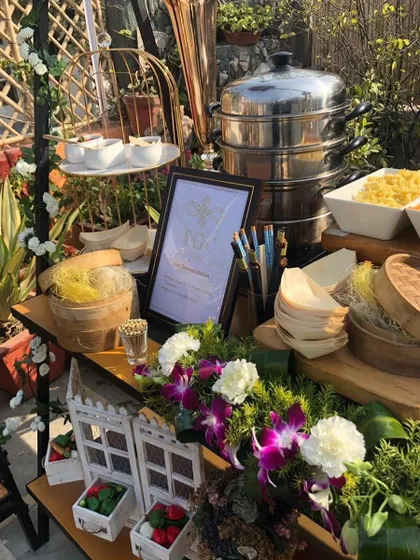 My live dim sum station offers a taste of Asia. Here, a steamer is set up amidst a beautiful floral and greenery arrangement, ready to serve hot and fresh dim sums.