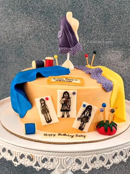 A duplicate of ID 43, this image shows the full fashion designer themed cake on a beautiful stand.
