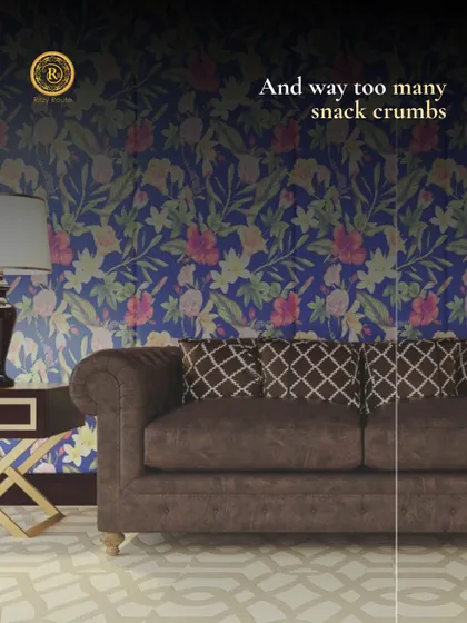 We design for real life, including the snack crumbs. This living room features a bold floral wallpaper and a comfortable chesterfield sofa, blending classic style with a touch of playfulness.