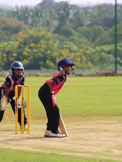 A U-10 batter and keeper in position, ready for the next ball. These early match experiences are crucial for development.
